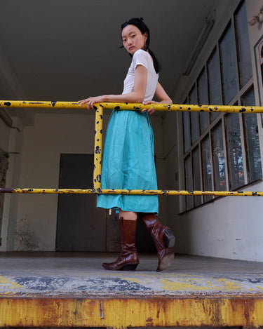 This is love at first sight. You'll fall for this vintage midi silk skirt in dreamy turquoise / light blue shading! Perfectly sized for XS. Please keep in mind that this skirt has some flaws such as rubbed material spot (last photo).