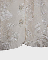 Experience the sparkle and shine of this vintage 80s white shimmering blazer! Ideal for spring and summer, this blazer will elevate any outfit. Its flattering fit and playful touch make it a must-have for adding vintage glam to your wardrobe.