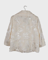 Experience the sparkle and shine of this vintage 80s white shimmering blazer! Ideal for spring and summer, this blazer will elevate any outfit. Its flattering fit and playful touch make it a must-have for adding vintage glam to your wardrobe.