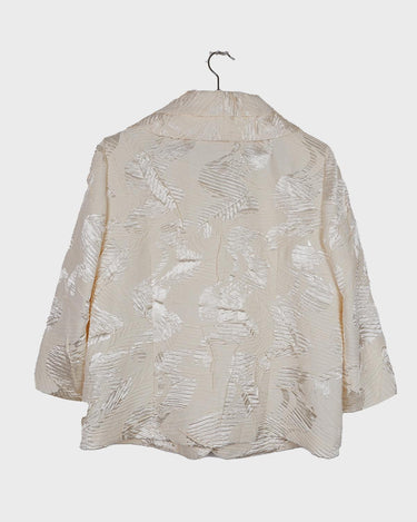 Experience the sparkle and shine of this vintage 80s white shimmering blazer! Ideal for spring and summer, this blazer will elevate any outfit. Its flattering fit and playful touch make it a must-have for adding vintage glam to your wardrobe.