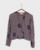 Say goodbye to boring blouses with this vintage 80s geometric masterpiece! Made from a luxurious silk mix, this blouse is a dream come true for those who love playful fashion.