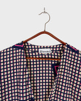 Say goodbye to boring blouses with this vintage 80s geometric masterpiece! Made from a luxurious silk mix, this blouse is a dream come true for those who love playful fashion.