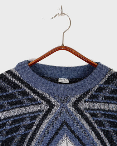 Get a laid back look with this vintage blue sweater from the 80s! Lightweight and perfect for spring, this sweater will add a pop of color to your wardrobe. It's perfect for a relaxed and effortless style.