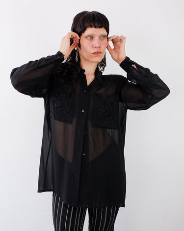 Vintage 80s 90s black mesh long sleeve blouse with embroidered front pockets and shoulder pads | S-XL