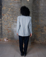 Give your wardrobe an edge with this grey spring double row buttons blazer from the 80s! With subtle yet stylish shoulder pads and a thin design, this blazer will add a touch of timeless vintage charm to any outfit.