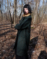 Experience true vintage elegance with this stunning green wool coat from the 70s/80s. Beautiful brown accents add a stylish touch, while the real fur collar adds a luxurious and statement-making element.