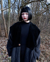 Add some edge to your wardrobe with this Vintage 80s/90s wool coat. The dark grey/black color combination and velvet hood give off a grunge vibe!