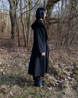 Add some edge to your wardrobe with this Vintage 80s/90s wool coat. The dark grey/black color combination and velvet hood give off a grunge vibe!