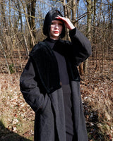 Add some edge to your wardrobe with this Vintage 80s/90s wool coat. The dark grey/black color combination and velvet hood give off a grunge vibe!