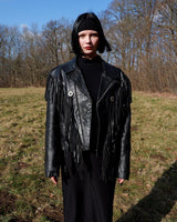 Add some wild vibes to your wardrobe with this vintage 80s 90s black fringe leather jacket. Complete with conchos and a belt, this jacket will be a statement piece for any outfit.