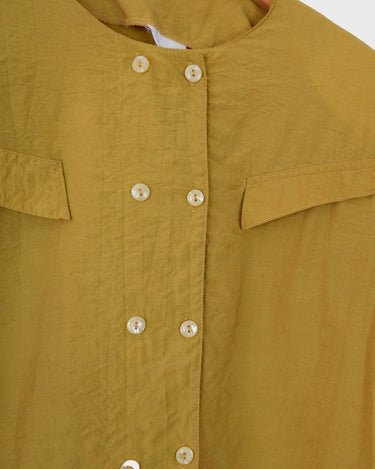 This Vintage 80s yellow short sleeve blouse is a double dose of 80s with its two rows of buttons and shoulder pads!