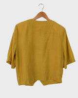 This Vintage 80s yellow short sleeve blouse is a double dose of 80s with its two rows of buttons and shoulder pads!