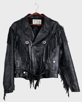 Add some wild vibes to your wardrobe with this vintage 80s 90s black fringe leather jacket. Complete with conchos and a belt, this jacket will be a statement piece for any outfit.