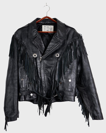 Add some wild vibes to your wardrobe with this vintage 80s 90s black fringe leather jacket. Complete with conchos and a belt, this jacket will be a statement piece for any outfit.