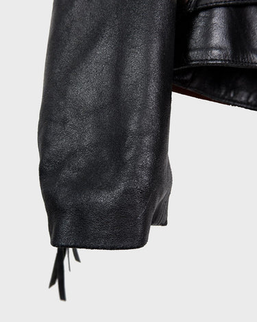 Add some wild vibes to your wardrobe with this vintage 80s 90s black fringe leather jacket. Complete with conchos and a belt, this jacket will be a statement piece for any outfit.