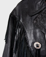 Add some wild vibes to your wardrobe with this vintage 80s 90s black fringe leather jacket. Complete with conchos and a belt, this jacket will be a statement piece for any outfit.