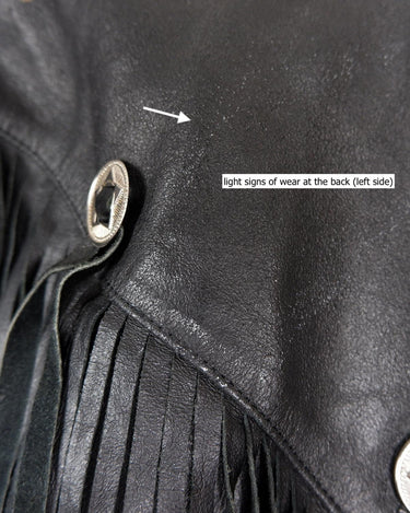 Add some wild vibes to your wardrobe with this vintage 80s 90s black fringe leather jacket. Complete with conchos and a belt, this jacket will be a statement piece for any outfit.