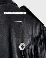 Add some wild vibes to your wardrobe with this vintage 80s 90s black fringe leather jacket. Complete with conchos and a belt, this jacket will be a statement piece for any outfit.