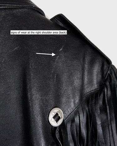 Add some wild vibes to your wardrobe with this vintage 80s 90s black fringe leather jacket. Complete with conchos and a belt, this jacket will be a statement piece for any outfit.