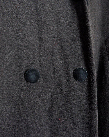 Add some edge to your wardrobe with this Vintage 80s/90s wool coat. The dark grey/black color combination and velvet hood give off a grunge vibe!