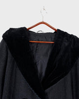 Add some edge to your wardrobe with this Vintage 80s/90s wool coat. The dark grey/black color combination and velvet hood give off a grunge vibe!