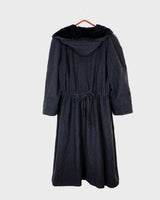 Add some edge to your wardrobe with this Vintage 80s/90s wool coat. The dark grey/black color combination and velvet hood give off a grunge vibe!