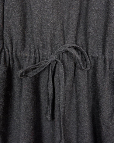 Add some edge to your wardrobe with this Vintage 80s/90s wool coat. The dark grey/black color combination and velvet hood give off a grunge vibe!