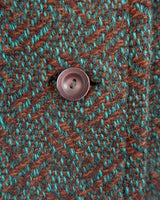 Experience true vintage elegance with this stunning green wool coat from the 70s/80s. Beautiful brown accents add a stylish touch, while the real fur collar adds a luxurious and statement-making element.