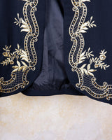 Embrace this Vintage 80s Spring Blazer! Featuring golden stitches and shoulder pads, this blazer (no closure) is definitely a statement piece. The floral and geometric pattern adds an extra touch of playfulness to any outfit. 