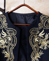 Embrace this Vintage 80s Spring Blazer! Featuring golden stitches and shoulder pads, this blazer (no closure) is definitely a statement piece. The floral and geometric pattern adds an extra touch of playfulness to any outfit. 