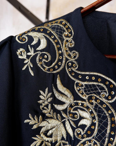 Embrace this Vintage 80s Spring Blazer! Featuring golden stitches and shoulder pads, this blazer (no closure) is definitely a statement piece. The floral and geometric pattern adds an extra touch of playfulness to any outfit. 