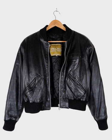 This iconic Vintage 80s black bomber leather jacket brings the edge with a serious dose of attitude! Boasting shoulder pads and a classic bomber jacket silhouette, it's sure to unleash your inner wild child!