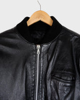 This iconic Vintage 80s black bomber leather jacket brings the edge with a serious dose of attitude! Boasting shoulder pads and a classic bomber jacket silhouette, it's sure to unleash your inner wild child!