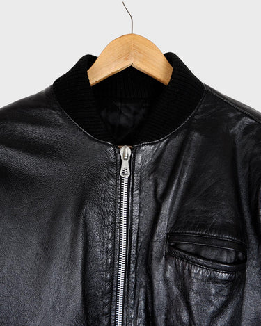 This iconic Vintage 80s black bomber leather jacket brings the edge with a serious dose of attitude! Boasting shoulder pads and a classic bomber jacket silhouette, it's sure to unleash your inner wild child!