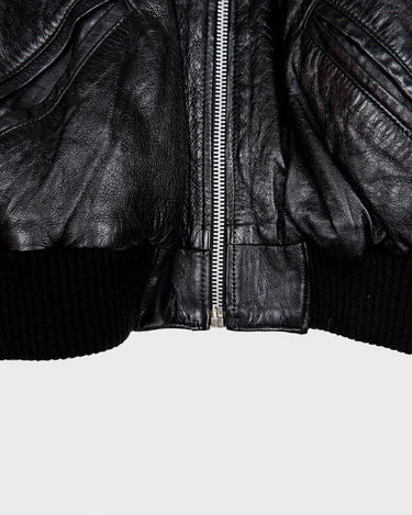 This iconic Vintage 80s black bomber leather jacket brings the edge with a serious dose of attitude! Boasting shoulder pads and a classic bomber jacket silhouette, it's sure to unleash your inner wild child!