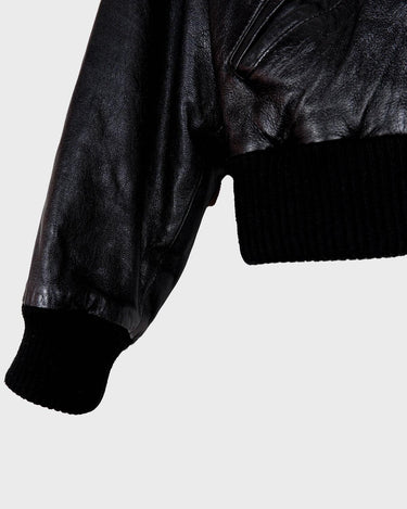 This iconic Vintage 80s black bomber leather jacket brings the edge with a serious dose of attitude! Boasting shoulder pads and a classic bomber jacket silhouette, it's sure to unleash your inner wild child!