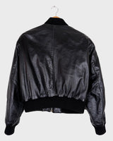 This iconic Vintage 80s black bomber leather jacket brings the edge with a serious dose of attitude! Boasting shoulder pads and a classic bomber jacket silhouette, it's sure to unleash your inner wild child!
