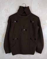 This Vintage 90s brown wool sweater is sure to make a statement with its unique cut outs. Made from high-quality wool, it's perfect for staying cozy while still showing off some skin.