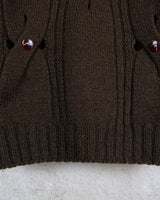 This Vintage 90s brown wool sweater is sure to make a statement with its unique cut outs. Made from high-quality wool, it's perfect for staying cozy while still showing off some skin.