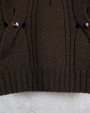 This Vintage 90s brown wool sweater is sure to make a statement with its unique cut outs. Made from high-quality wool, it's perfect for staying cozy while still showing off some skin.