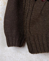 This Vintage 90s brown wool sweater is sure to make a statement with its unique cut outs. Made from high-quality wool, it's perfect for staying cozy while still showing off some skin.