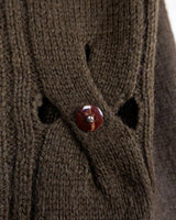 This Vintage 90s brown wool sweater is sure to make a statement with its unique cut outs. Made from high-quality wool, it's perfect for staying cozy while still showing off some skin.