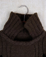 This Vintage 90s brown wool sweater is sure to make a statement with its unique cut outs. Made from high-quality wool, it's perfect for staying cozy while still showing off some skin.