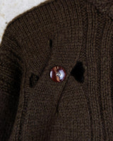 This Vintage 90s brown wool sweater is sure to make a statement with its unique cut outs. Made from high-quality wool, it's perfect for staying cozy while still showing off some skin.