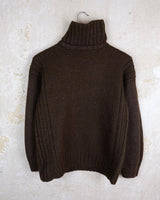 This Vintage 90s brown wool sweater is sure to make a statement with its unique cut outs. Made from high-quality wool, it's perfect for staying cozy while still showing off some skin.