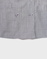 Give your wardrobe an edge with this grey spring double row buttons blazer from the 80s! With subtle yet stylish shoulder pads and a thin design, this blazer will add a touch of timeless vintage charm to any outfit.