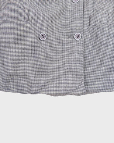 Give your wardrobe an edge with this grey spring double row buttons blazer from the 80s! With subtle yet stylish shoulder pads and a thin design, this blazer will add a touch of timeless vintage charm to any outfit.