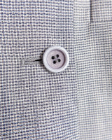 Give your wardrobe an edge with this grey spring double row buttons blazer from the 80s! With subtle yet stylish shoulder pads and a thin design, this blazer will add a touch of timeless vintage charm to any outfit.