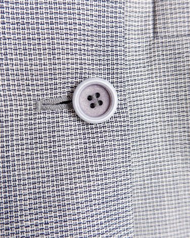 Give your wardrobe an edge with this grey spring double row buttons blazer from the 80s! With subtle yet stylish shoulder pads and a thin design, this blazer will add a touch of timeless vintage charm to any outfit.