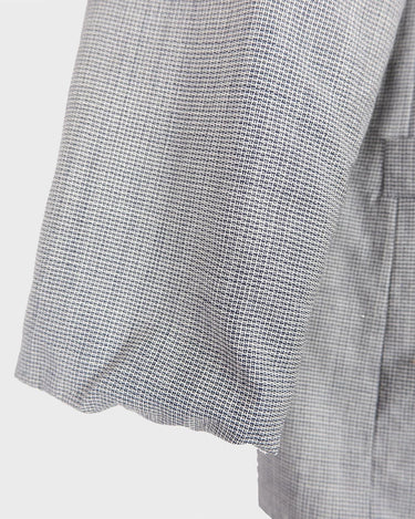 Give your wardrobe an edge with this grey spring double row buttons blazer from the 80s! With subtle yet stylish shoulder pads and a thin design, this blazer will add a touch of timeless vintage charm to any outfit.